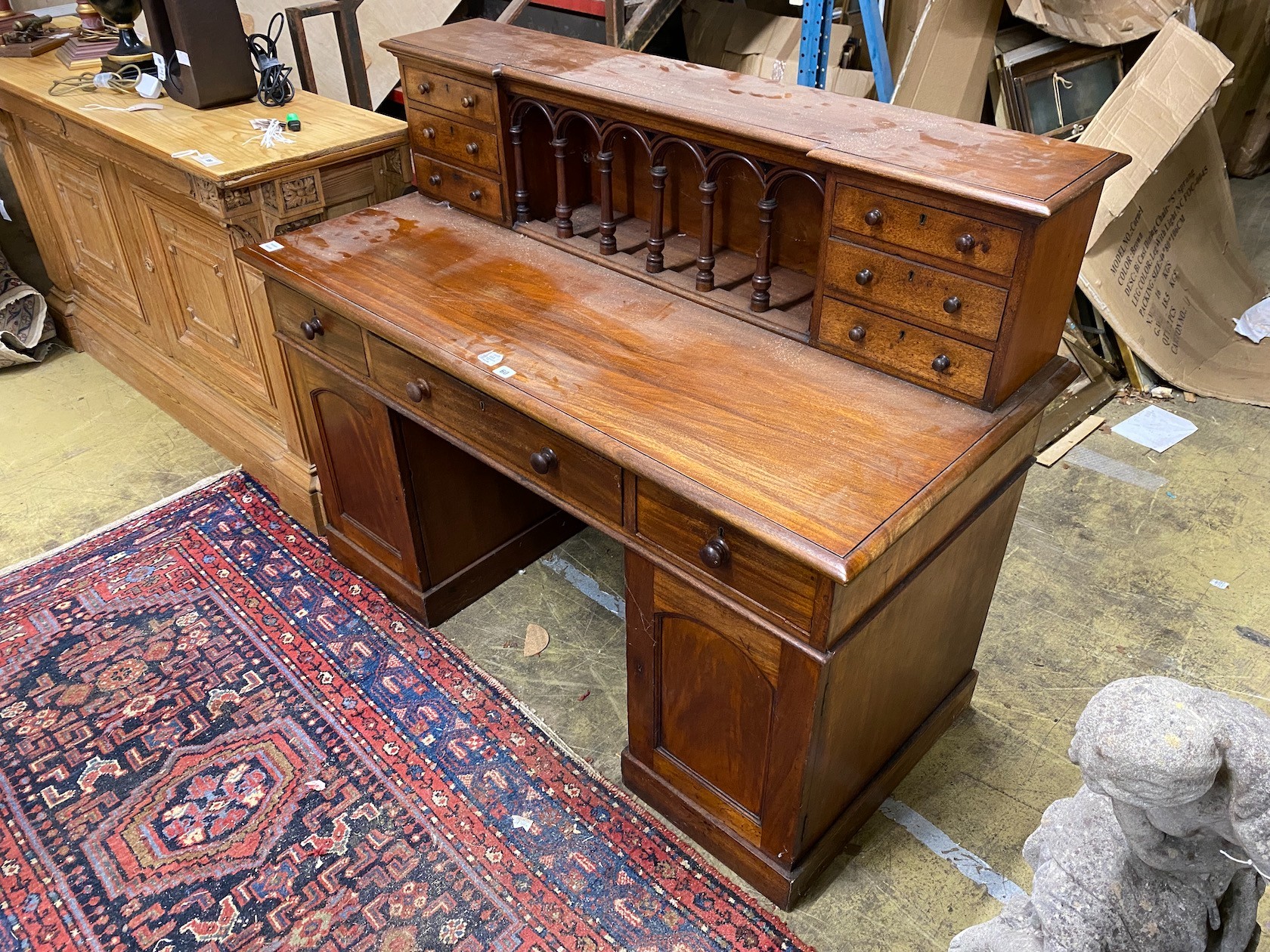 A Victorian style hardwood kneehole desk with galleried superstructure, length 140cm, depth 64cm, height 112cm